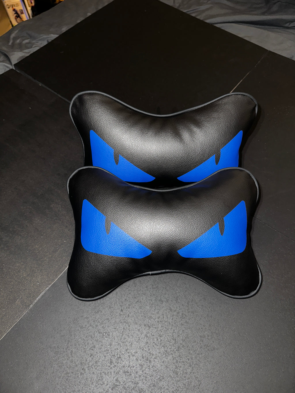 Black and blue neck pillow on a car seat